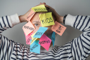 Mental load concept - female has post-it notes with social responcibilities on her face. High quality photo